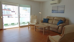 A living room with a sofa, armchair, and coffee table. - Terrasol Caracola 6-b3 (Velez-Malaga)