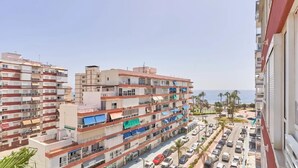 A multi-story residential building with balconies, a parking lot, and a view of the sea. - Terrasol Franlou Vistas AL MAR (Velez-Malaga)