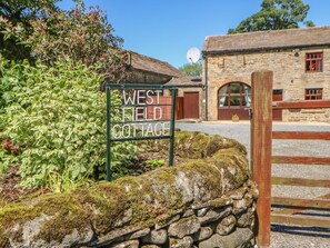 A stone wall with a sign for 'West Field Cottage.' - Westfield Cottage, Mickleton, Teesdale (Barnard Castle)