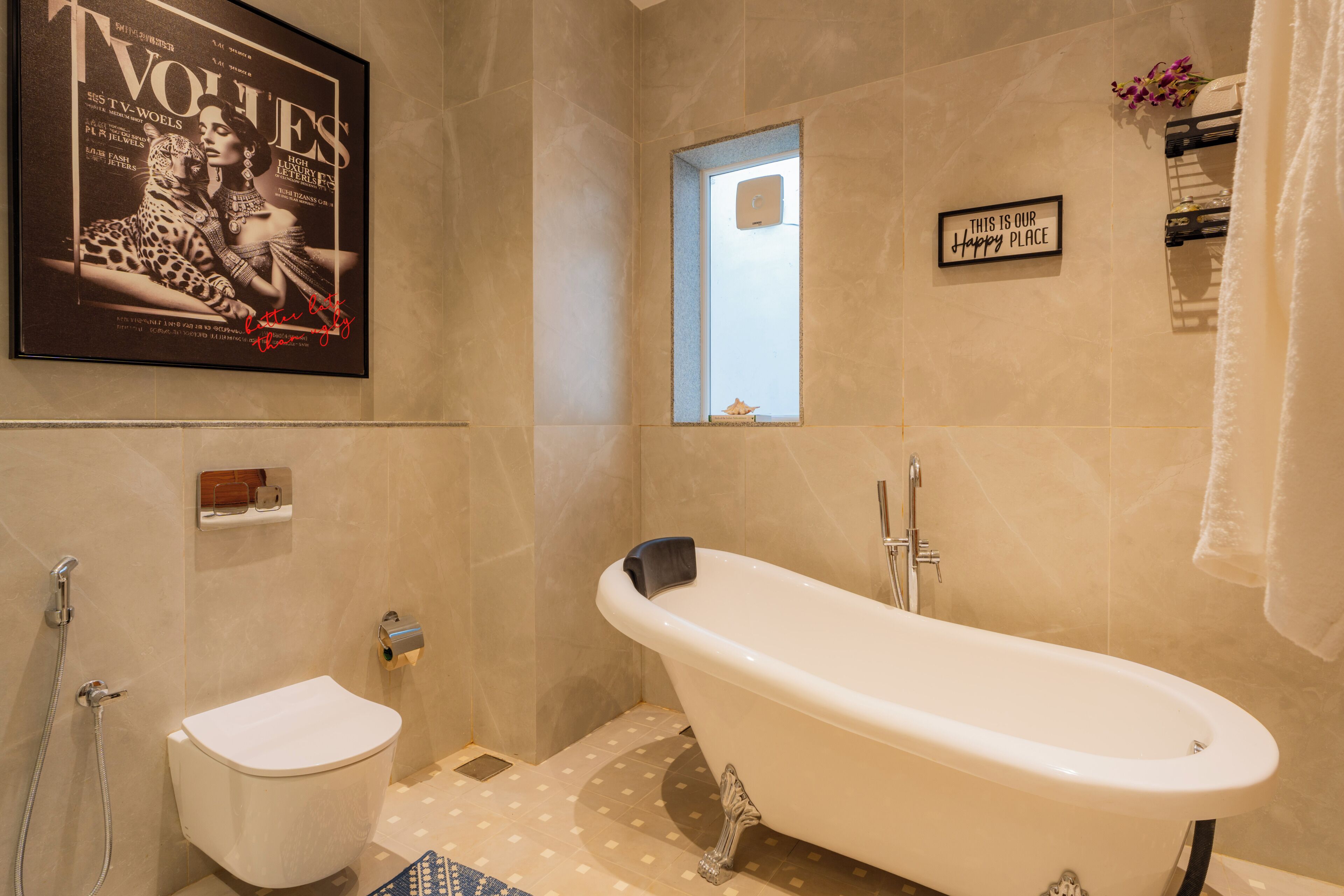 A bathroom with a bathtub, toilet, and a framed magazine on the wall.