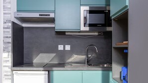 A compact kitchen with a built-in microwave, a stainless steel sink, and a dishwasher. - Studio in Avoriaz, south - 4 guests (Avoriaz)
