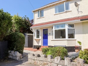 A two-story house with a blue door, a satellite dish, and a small shed in the yard. - 13 The Crescent, Rhos-On-Sea (Bae Colwyn)
