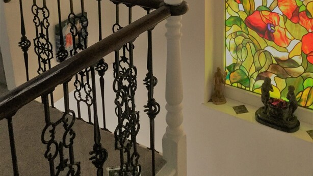 A staircase with ornate black iron railings and white columns. - Peaceful 1-bedroom apartment in welcoming London neighborhood (London)
