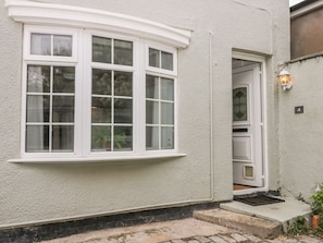 A building with a white exterior, a large window, and a door with a small step leading to the entrance. - Witts End, Marske-By-The-Sea (Redcar)