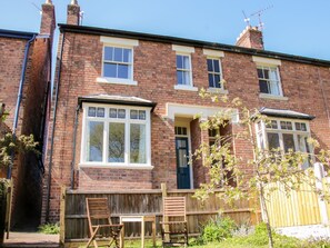 A two-story brick house with a front door, windows, and a wooden fence. - Willow View, Shrewsbury (Shrewsbury)