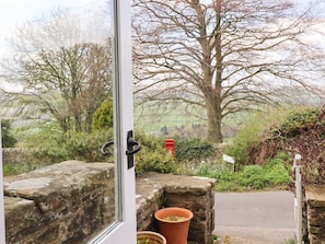 A stone wall, a red mailbox, and a tree in a rural setting. - Silver Hill Cottage, Pateley Bridge (Harrogate)