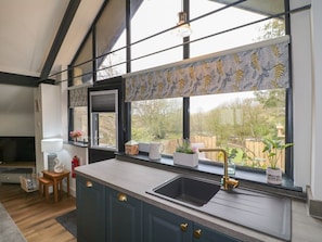 A kitchen with a large window, a sink, and a wooden chair. - Stoney Rock Studio , Waterhouses (Stoke-on-Trent)