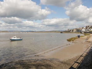 A calm river with a small boat, a sandy beach, and a distant bridge. - West View, Milnthorpe (Milnthorpe)