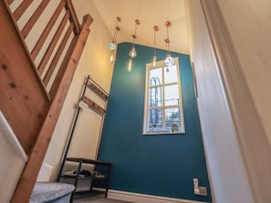 A staircase with wooden railings, a blue wall, a window with a view, and hanging light fixtures. - West View, Milnthorpe (Milnthorpe)