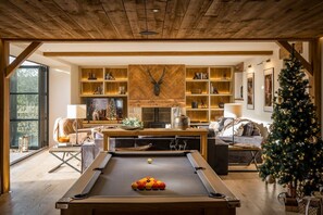 A cozy living room with a pool table, a fireplace, and a Christmas tree. - The Malt Kiln is nr Harrogate. (Harrogate)