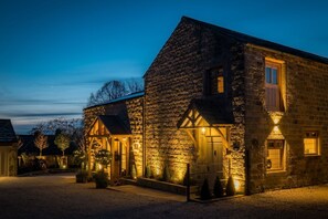 A stone building with a well-lit entrance and a covered porch. - The Malt Kiln is nr Harrogate. (Harrogate)