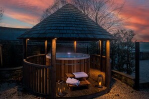 A wooden gazebo with a hot tub, benches, and a railing. - The Malt Kiln is nr Harrogate. (Harrogate)