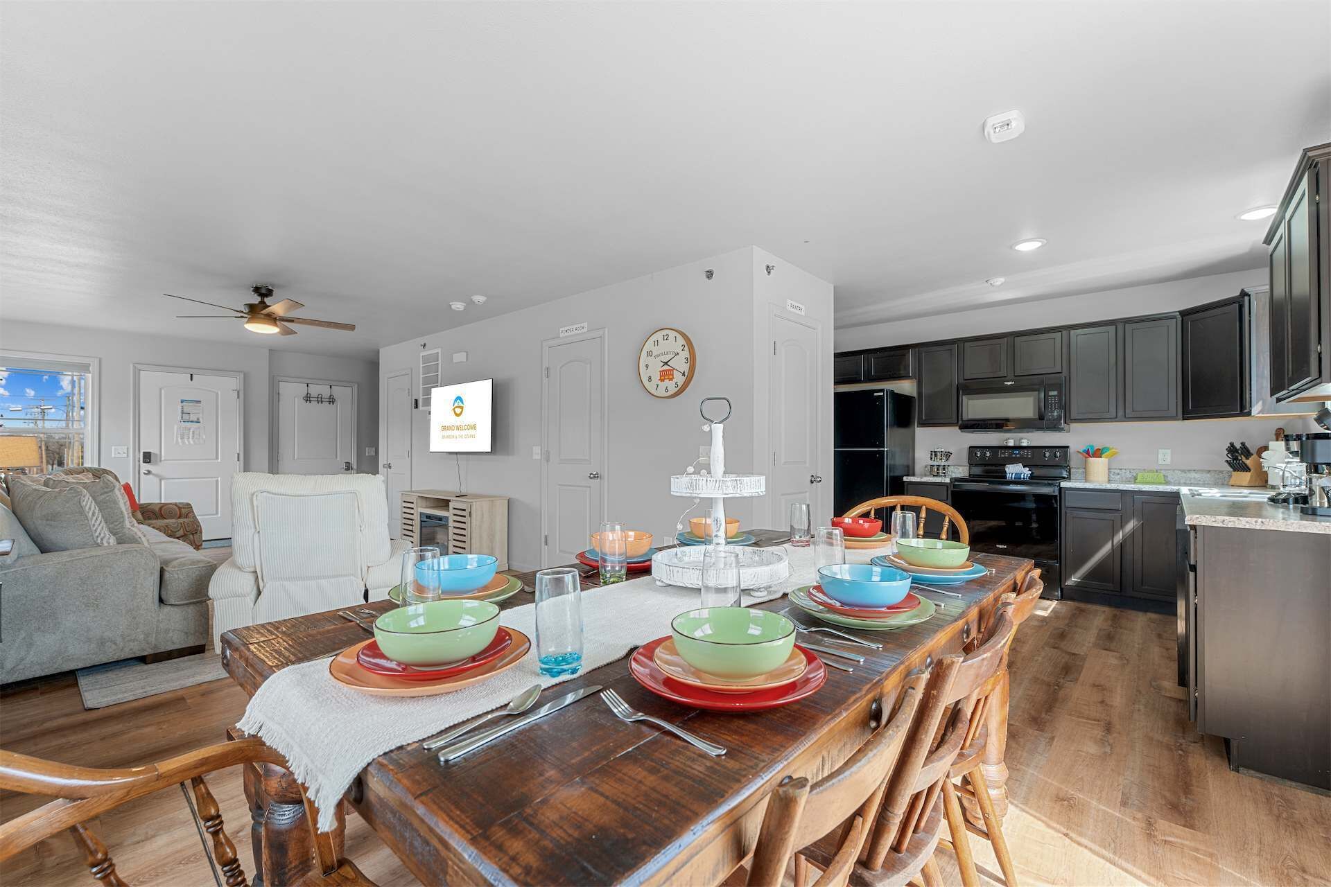 A modern kitchen with dark cabinets, a microwave, and an oven.