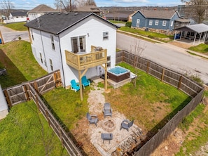 A two-story house with a deck, a hot tub, and outdoor seating. - Trolly Inn Hot Tub, Walkable (Branson)