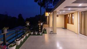 A modern building with a balcony, potted plants, and a view of the sky. - ELIVAAS The Nakshatra Serene 3BHK Villa (Sukha)