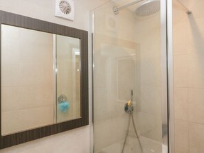 A modern bathroom with a glass shower enclosure, a large mirror, and a wall-mounted fan. - Lindeth Croft, Carnforth (Carnforth)