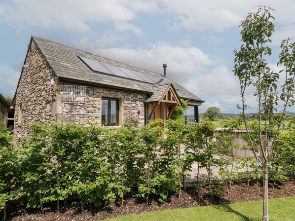 A stone house with a sloped roof, a chimney, and a balcony. - Lindeth Croft, Carnforth (Carnforth)
