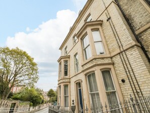 A corner building with large windows and a stone facade. - Charming Park View Apartment in Whitby (Whitby)
