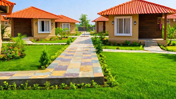 A row of single-story houses with red-tiled roofs, a central stone pathway, and well-maintained lawns.