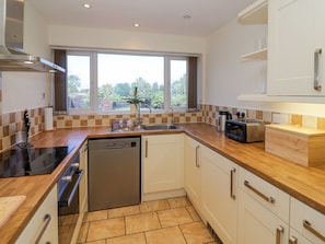 A modern kitchen with a dishwasher, stove, and microwave.