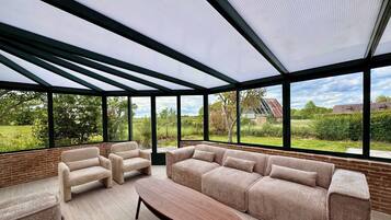 A modern living room with a sectional sofa, two armchairs, and a coffee table.
