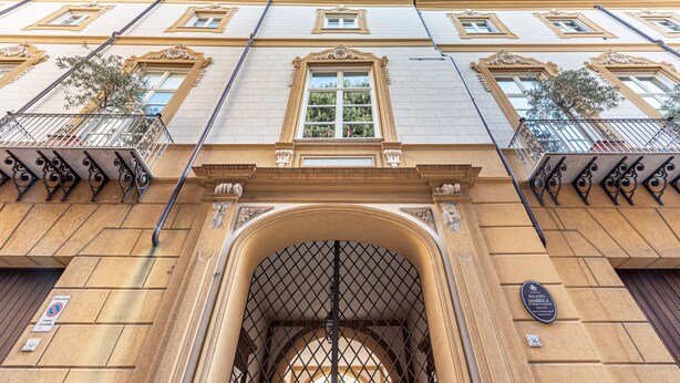 A building facade with a large arched entrance, ornate window frames, and a plaque indicating the name 'Palacio de San Blas.' - Palazzo Sambuca Charming by Wonderful Italy (Palermo)
