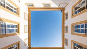 A building with multiple windows and a central skylight. - Palazzo Sambuca Charming by Wonderful Italy (Palermo)