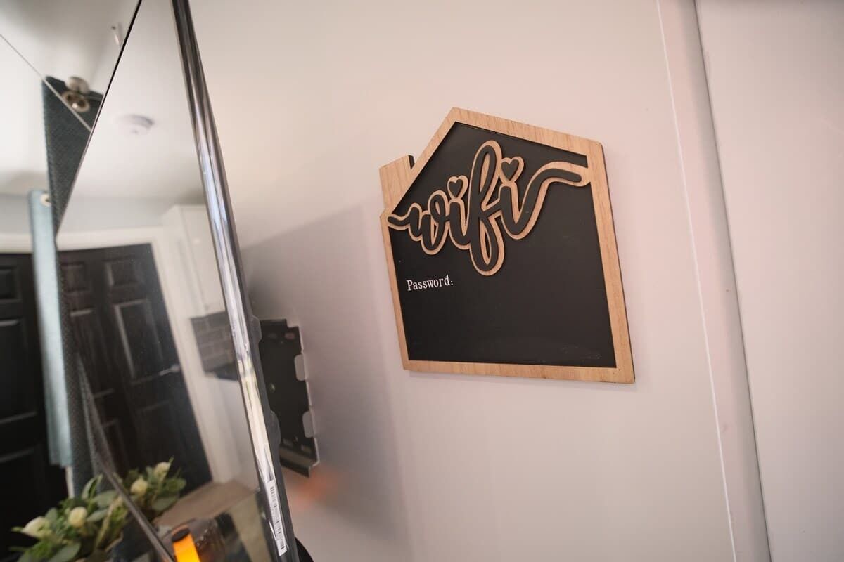 A wall-mounted sign with the word 'wifi' and a partial word 'Password' visible.