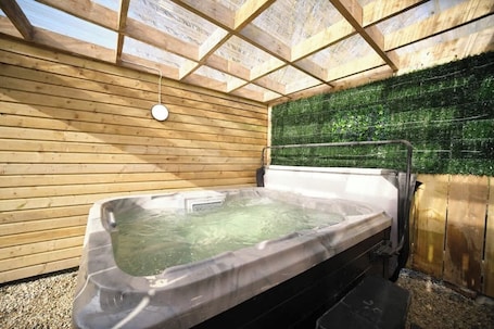Outdoor spa tub. Countryside Retreat with Hot Tub & Playground