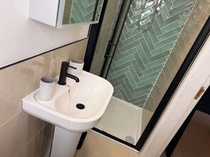 Shower, hair dryer, towels, shampoo