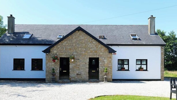 A two-story building with a stone facade, a pitched roof, and a gravel driveway. - 4BR Workers Accommodation | Sleeps 7 | Wi-Fi (Letterkenny)