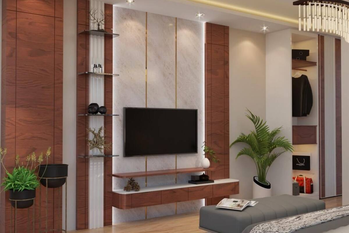 A modern living room with a flat-screen TV, wooden paneling, a built-in shelf, and a potted plant.