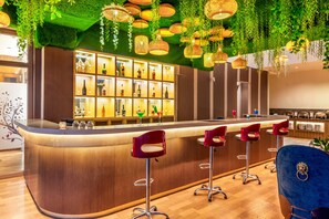 A bar area with a wooden counter, multiple stools, and a variety of bottles and glasses. - Lords Inn Sangam, Bhopal (Bhopal)