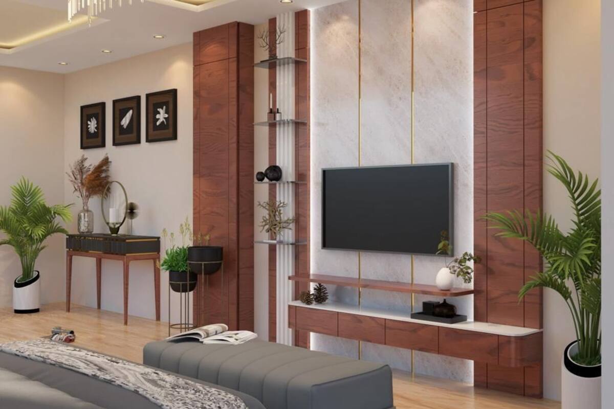 A modern living room with a flat-screen TV, wooden paneling, and potted plants.