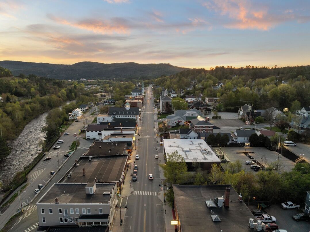 A town with a main street, buildings, and a river.