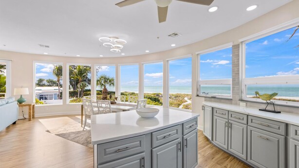 A modern kitchen with large windows, a ceiling fan, and a view of the beach. - 180 Degree Ocean Views Direct Access to Holmes Beach (Holmes Beach)