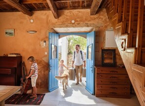 A rustic interior with a wooden ceiling, a blue door, a wooden dresser, and a guitar. - Opuntia Stone House in Gavalochori village. (Gavalochori)