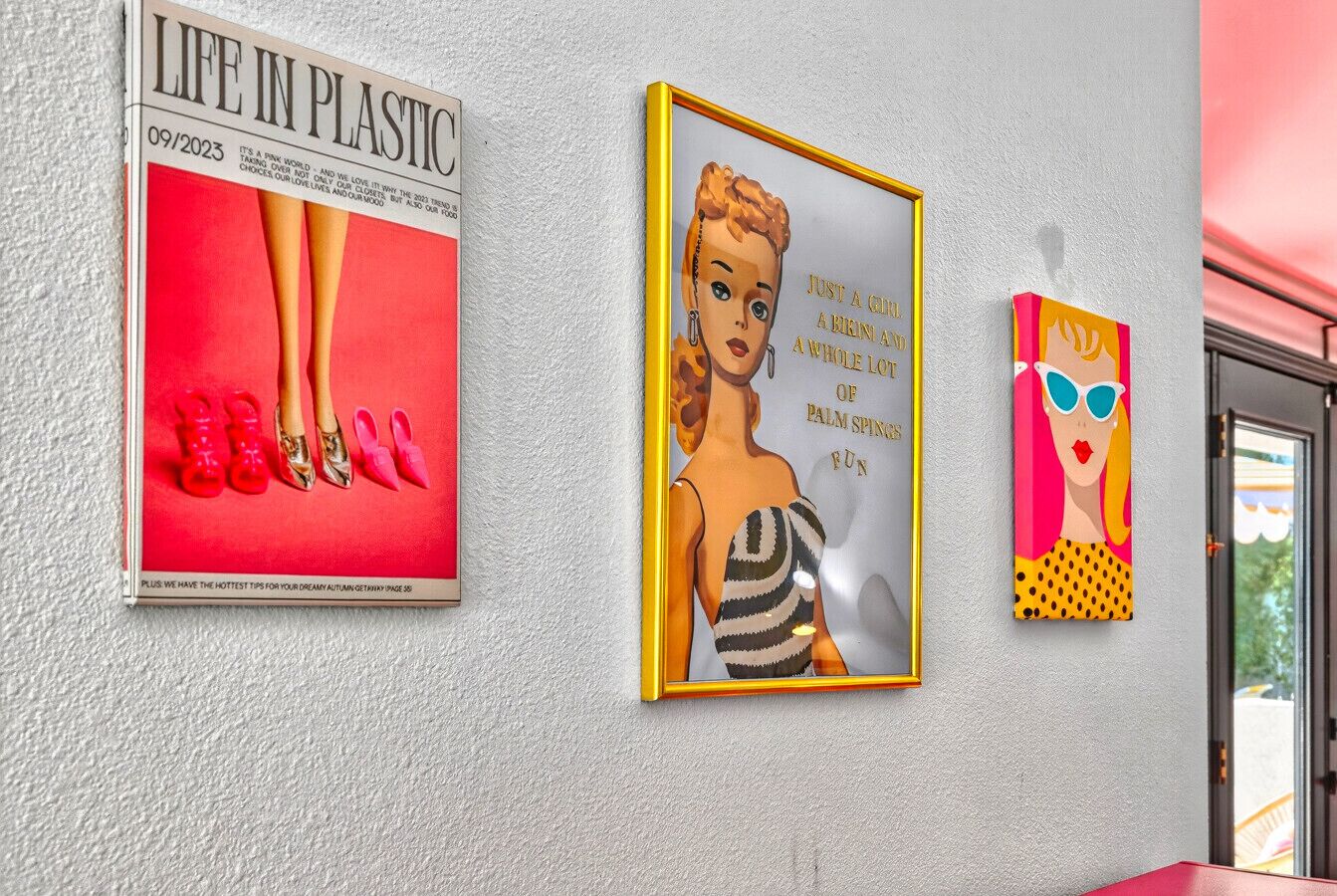 Three framed artworks on a wall.