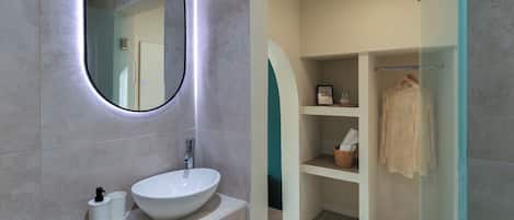 Deluxe Studio | Bathroom | Shower, hair dryer, towels, toilet paper