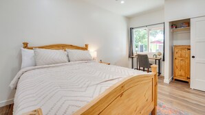 A bedroom with a wooden bed, a desk, a chair, and a wardrobe. - Outdoor Space, Near Everything: Glendale Getaway! (Glendale)