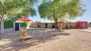 An outdoor area with a sandbox, wooden play structures, and red umbrellas. - Outdoor Space, Near Everything: Glendale Getaway! (Glendale)