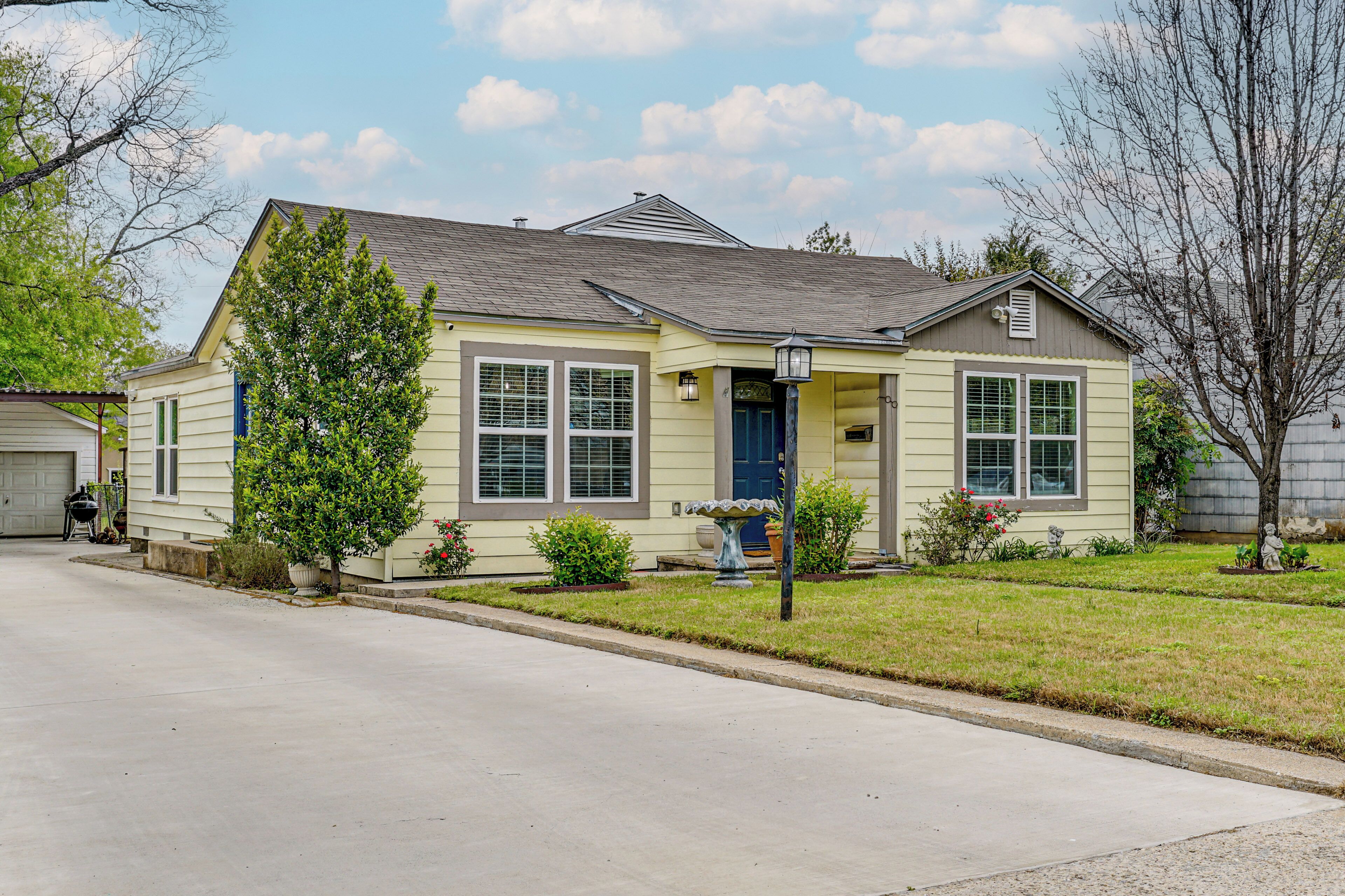 A single-story house with a front porch, a garage, and a well-maintained lawn.