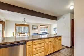 A kitchen with wooden cabinets, a stainless steel dishwasher, and a large island. - 3 Mi to Winter Park Resort! Mtn-view Condo (Winter Park)