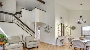 A spacious living area with a staircase, a dining table with chairs, and a chandelier. - Hot Tub, Pool & Socal Sunsets: San Diego Area Home (Spring Valley)
