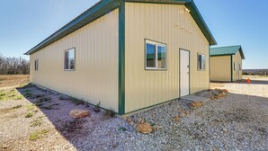 A single-story building with a flat roof, a door, and windows.