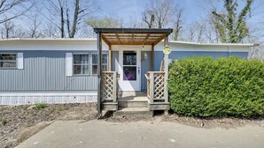 A mobile home with a porch, a door, and a small garden area. - 6 Mi to Fort Knox! Rural Family Home, Pets Welcome (Radcliff)