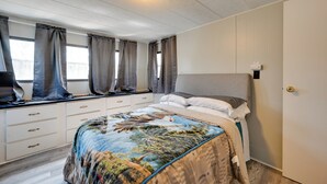 A bedroom with a bed, curtains, a nightstand, a dresser, and a ceiling light. - 6 Mi to Fort Knox! Rural Family Home, Pets Welcome (Radcliff)