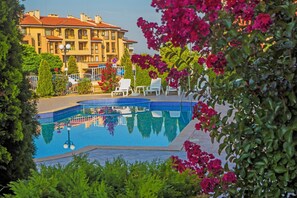 Seasonal outdoor pool, open 8:00 AM to 9:00 PM, pool umbrellas