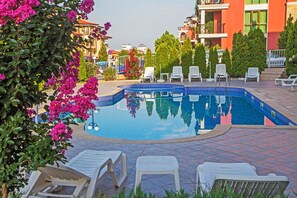 Seasonal outdoor pool, open 8:00 AM to 9:00 PM, pool umbrellas