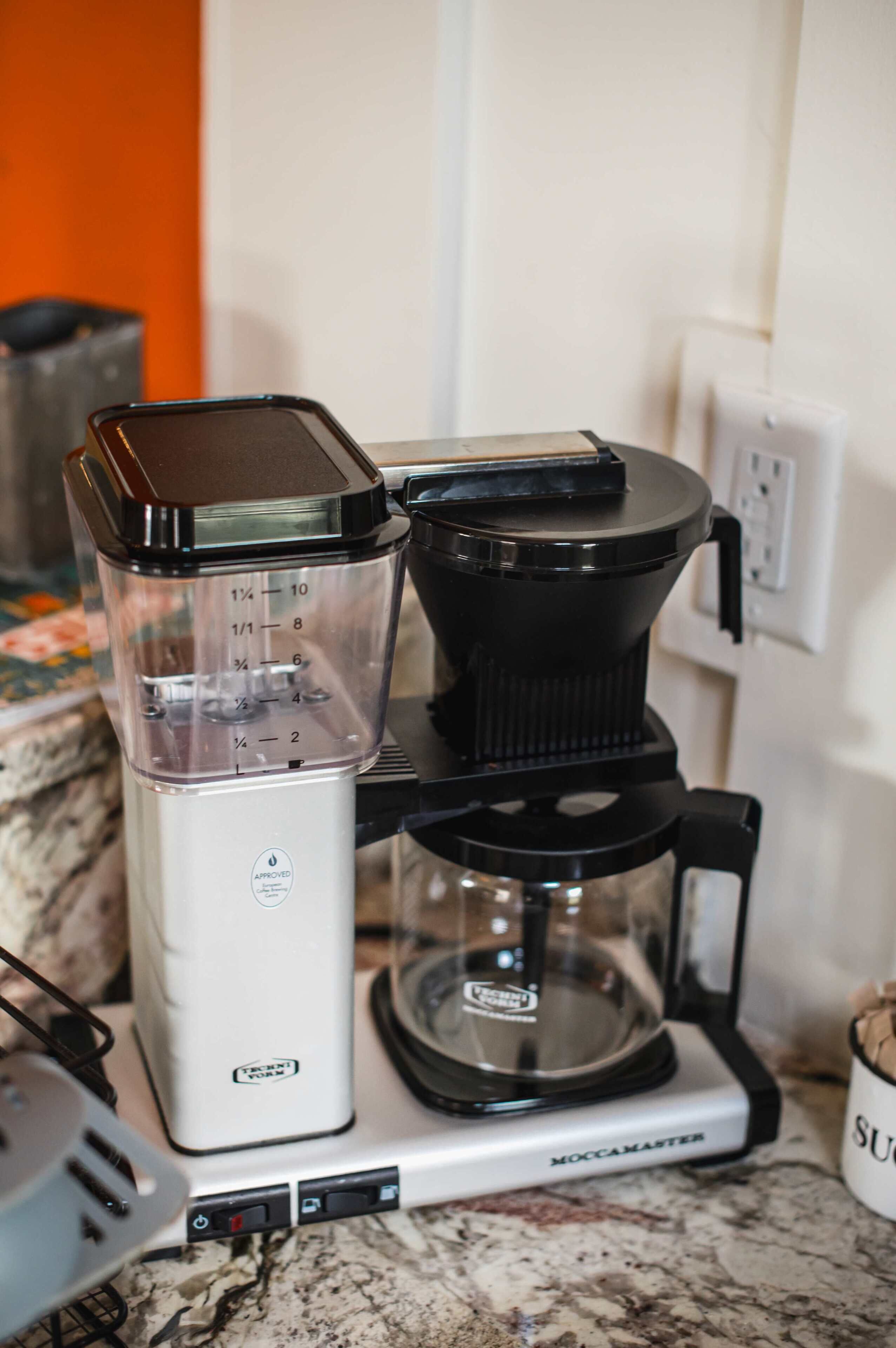 A kitchen with a coffee maker and a blender on the counter.